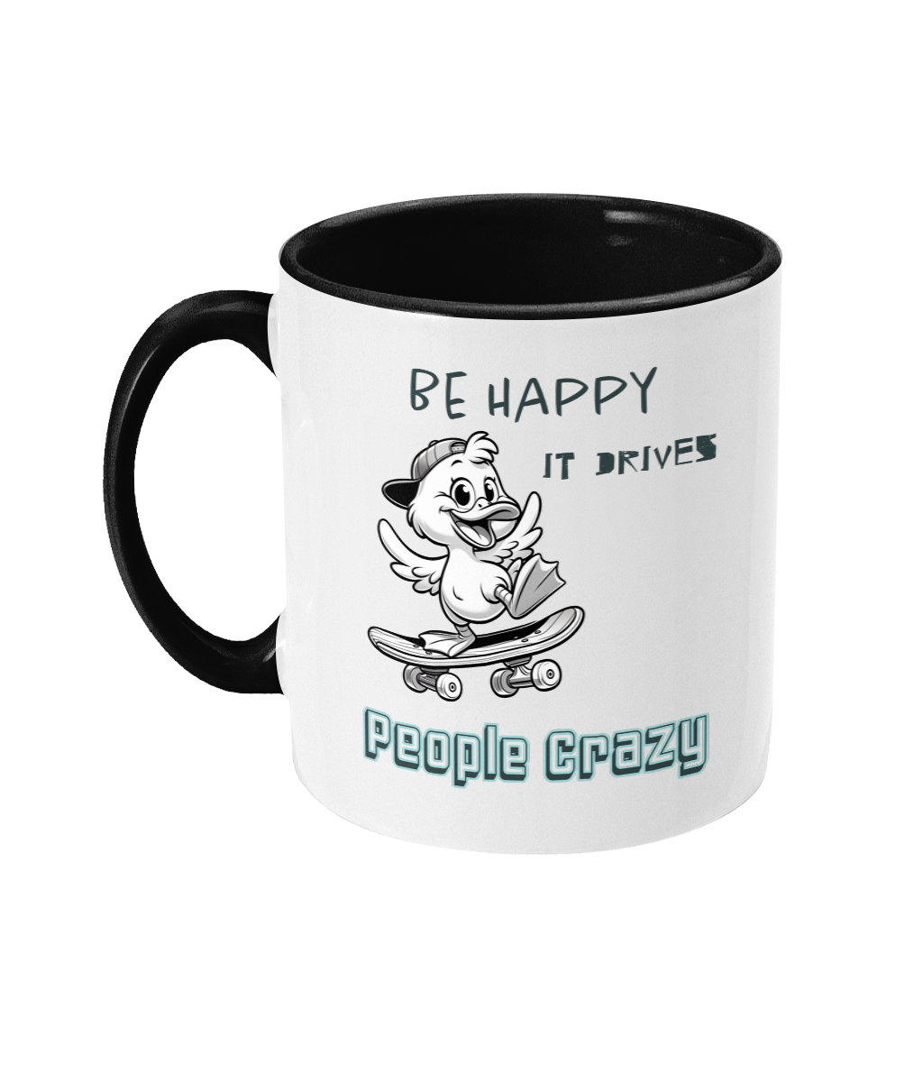 A white ceramic coffee mug with a black interior and handle, featuring the playful phrase “Be happy, it drives people crazy.” The design includes a black-and-white cartoon duck wearing a backward cap and riding a skateboard, adding a cheerful and quirky vibe to the mug. The text is styled in a mix of casual and bold fonts.