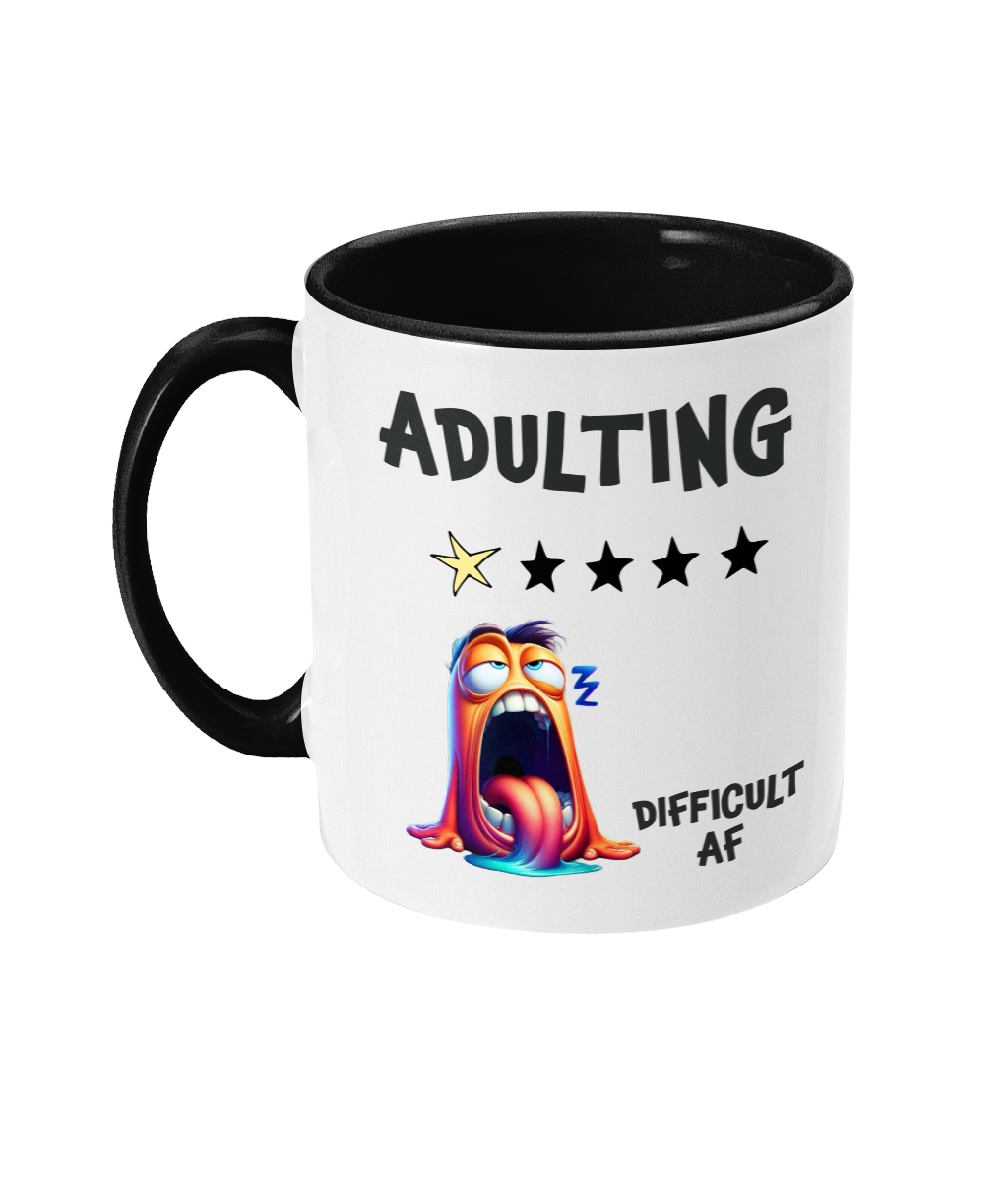  A white ceramic coffee mug with a black interior and handle, featuring humorous text that reads, “Adulting” with a 1-star rating out of 5 stars. Below the text, there’s a colorful, exaggerated cartoon character looking exhausted, with its tongue out and droopy eyes. The phrase “Difficult AF” is displayed near the bottom, adding a playful and relatable tone.