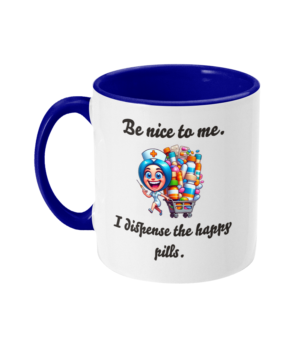 A white ceramic coffee mug with a blue interior and handle, featuring the humorous text, “Be nice to me. I dispense the happy pills.” The design includes a colorful cartoon illustration of a cheerful nurse holding a syringe and standing next to a cart overflowing with colorful pill bottles, adding a playful and lighthearted touch.