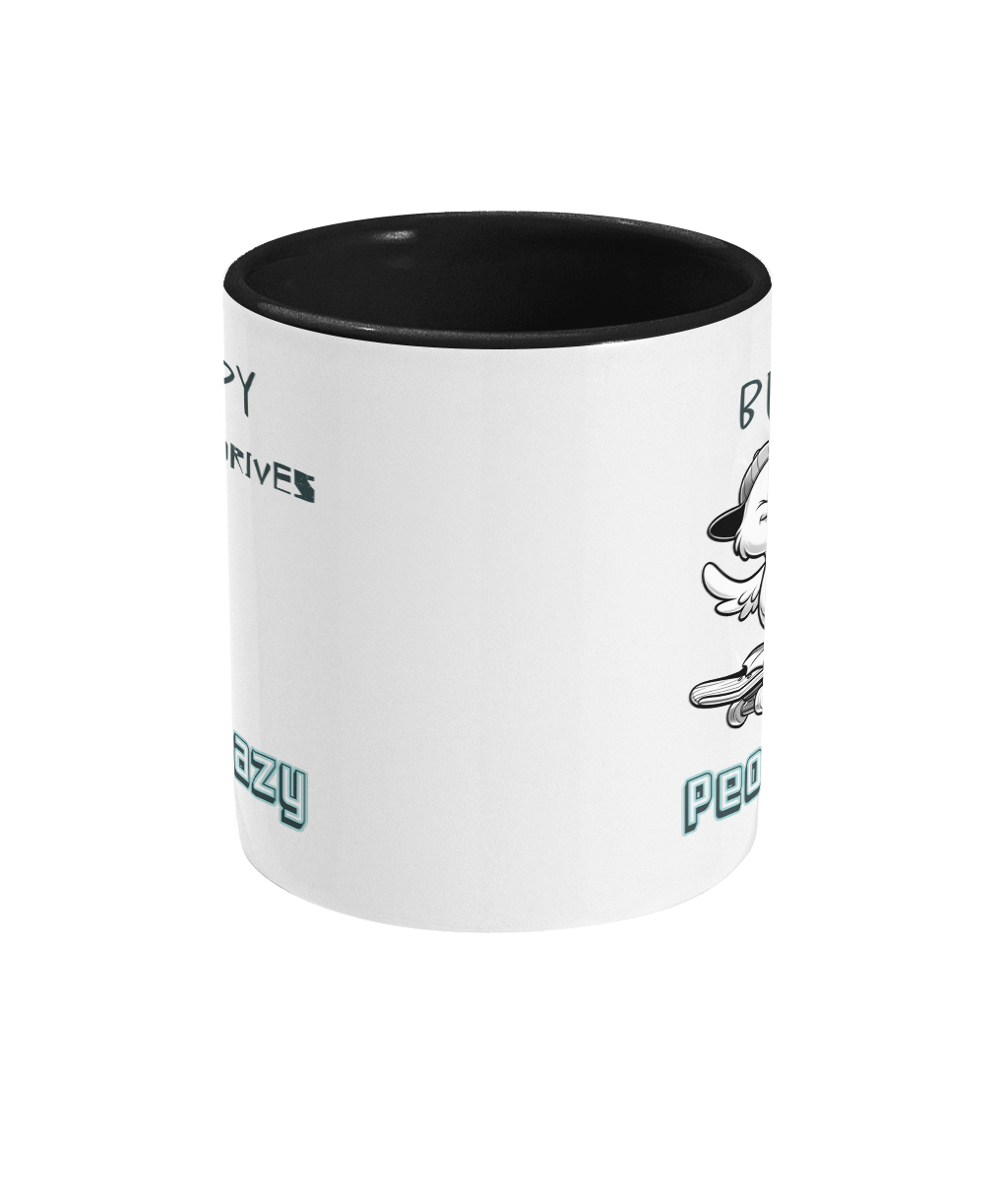 A white ceramic coffee mug with a black interior and handle, featuring the playful phrase “Be happy, it drives people crazy.” The design includes a black-and-white cartoon duck wearing a backward cap and riding a skateboard, adding a cheerful and quirky vibe to the mug. The text is styled in a mix of casual and bold fonts.