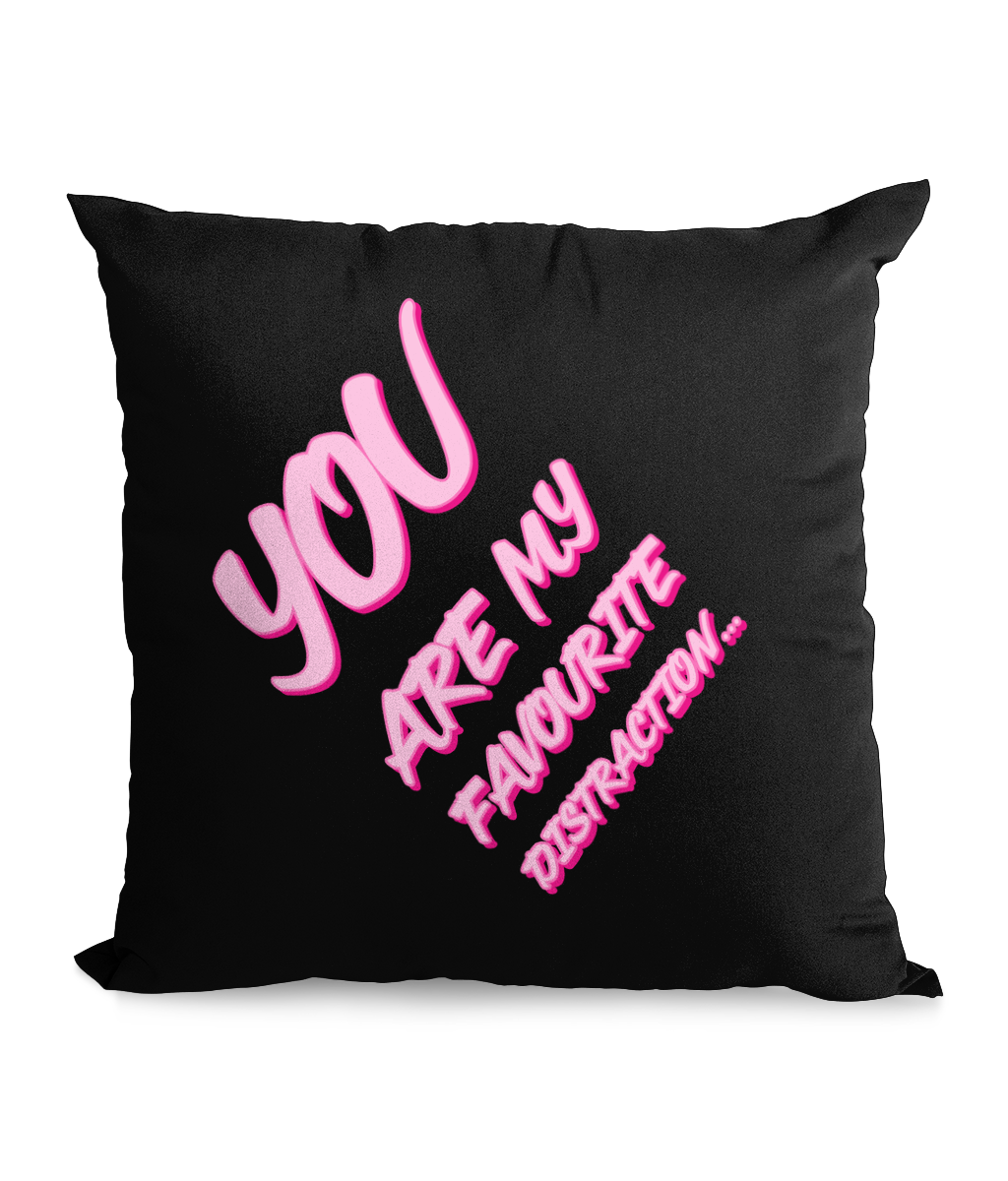 Black cushion with bold pink text reading ‘You Are My Favourite Distraction,’ tilted for a stylish, modern design.