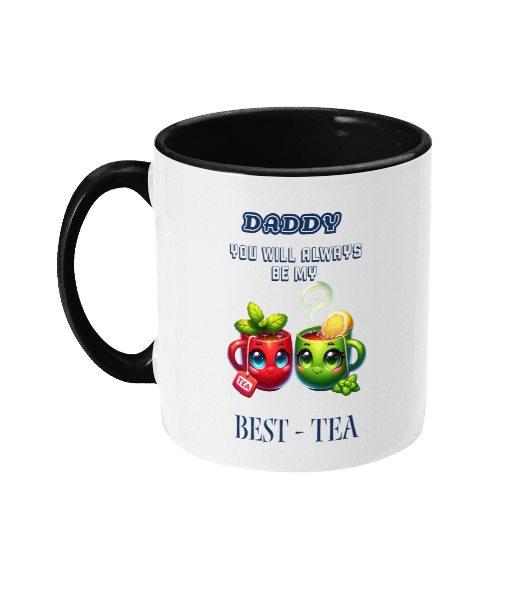  A white ceramic coffee mug with a black interior and handle, featuring the playful phrase, “Daddy, you will always be my best-tea.” The design includes two colorful cartoon teacups with smiling faces, one red with mint leaves and a tea tag, and one green with a lemon slice and steam rising, adding a cheerful and punny touch.