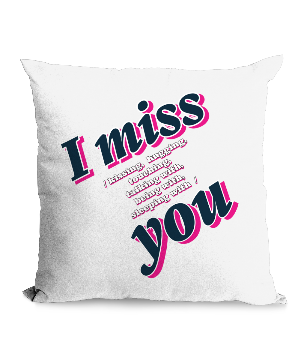 Black cushion with bold text: ‘I Miss You – Kissing, Hugging, Talking, Sleeping With You’ in pink and blue hues.”