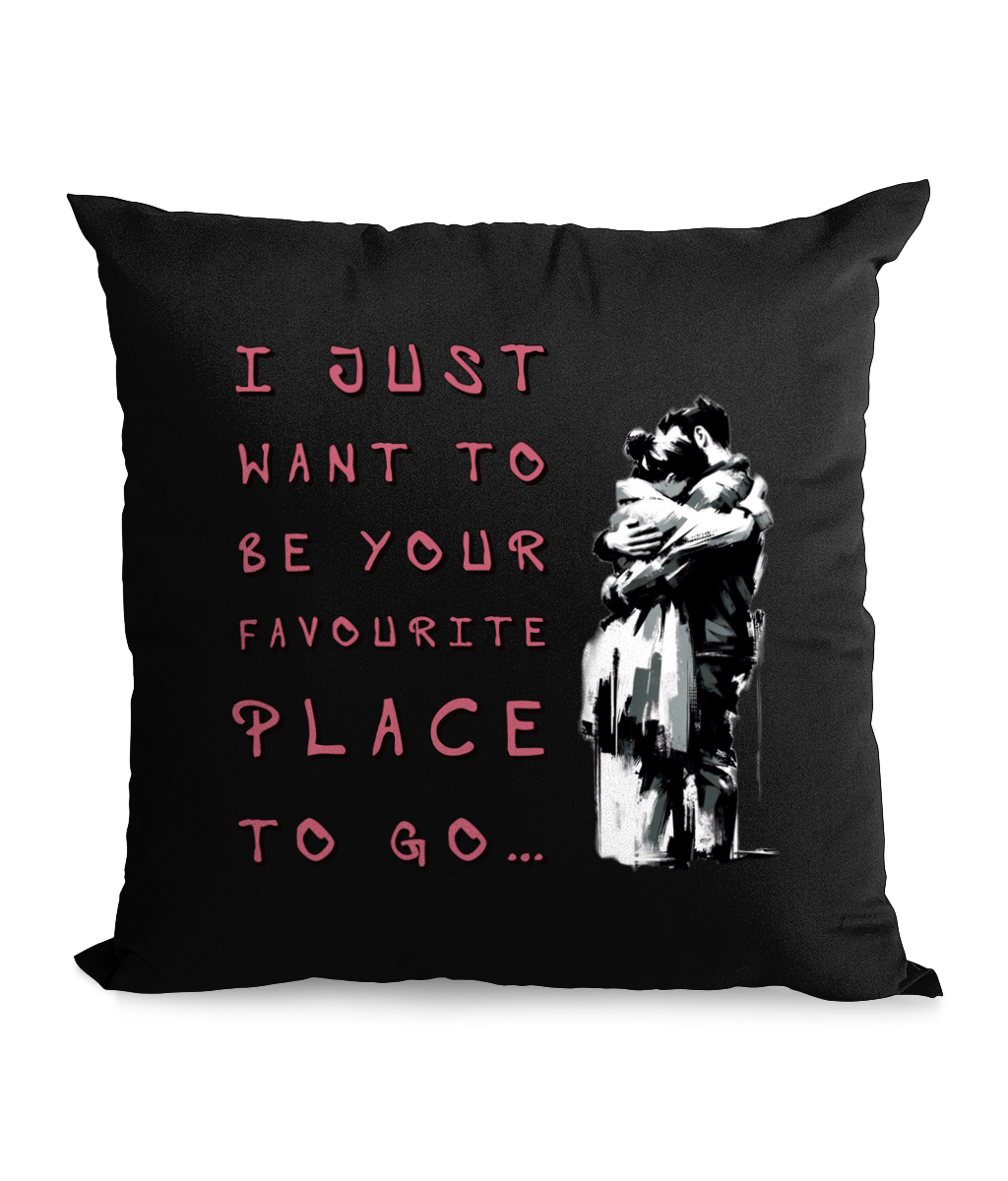 Black cushion with a couple embracing and the text: ‘I just want to be your favorite place to go.’”