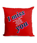 Black cushion with bold text: ‘I Miss You – Kissing, Hugging, Talking, Sleeping With You’ in pink and blue hues.”