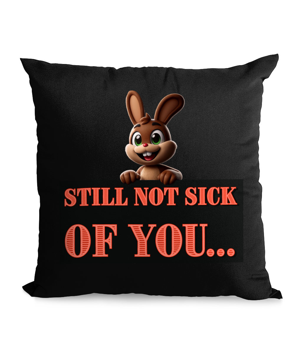 Black cushion with a cute cartoon bunny and the quote ‘Still Not Sick of You’ in bold red letters.”