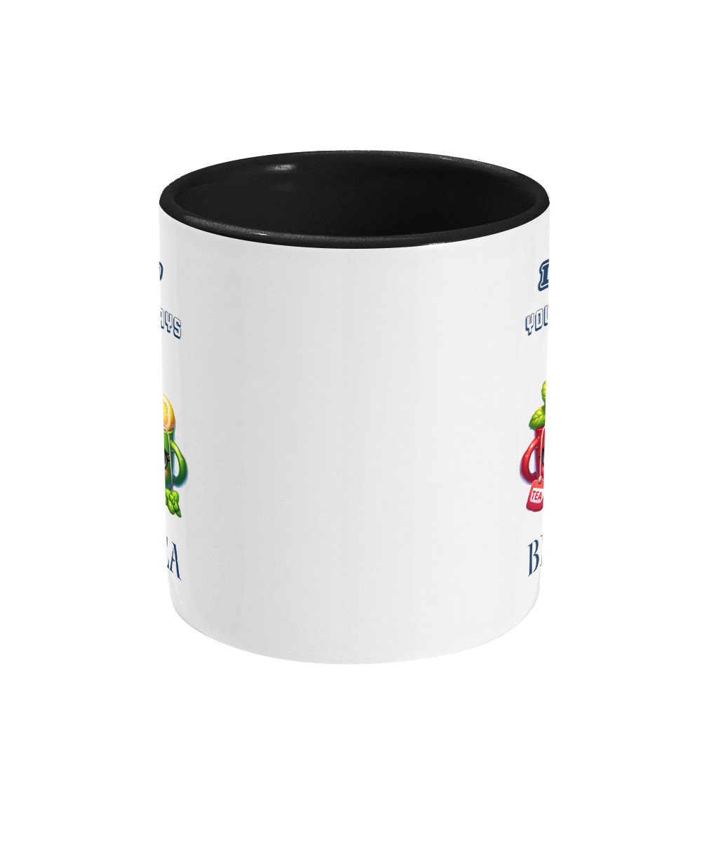  A white ceramic coffee mug with a black interior and handle, featuring the playful phrase, “Daddy, you will always be my best-tea.” The design includes two colorful cartoon teacups with smiling faces, one red with mint leaves and a tea tag, and one green with a lemon slice and steam rising, adding a cheerful and punny touch.